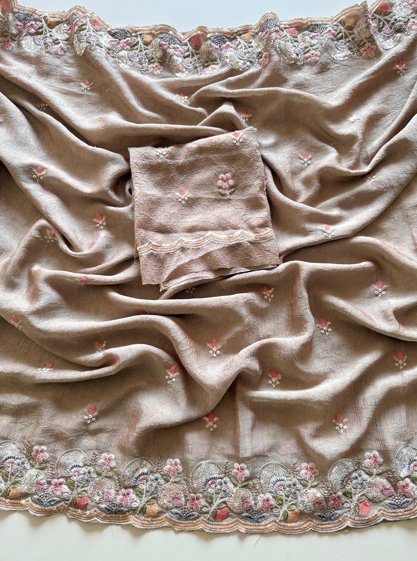 Beige fabric with floral embroidery on a plain background-Premium designer sequin saree in crush silk with embroidery blouse