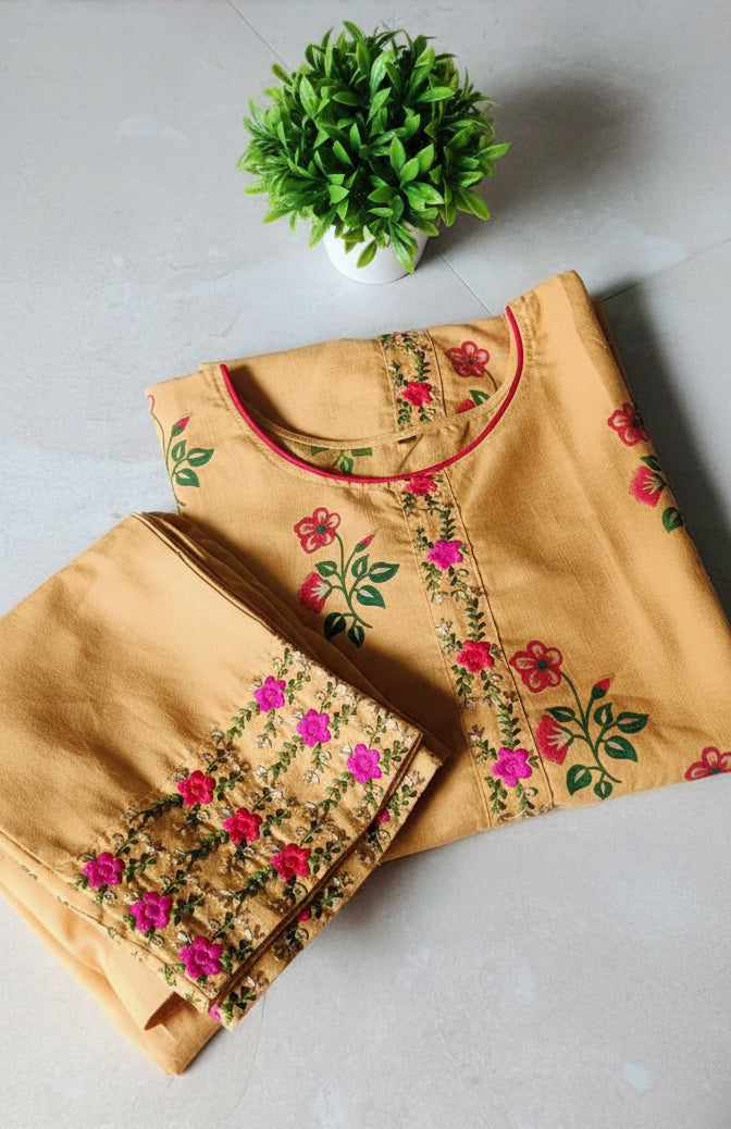 Beige outfit with floral embroidery on a white surface with a floral patterned background