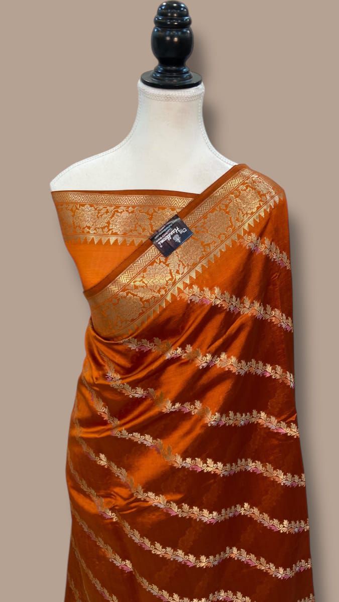 Orange Banarasi Mina Laheriya saree with golden zari border and jacquard detailing