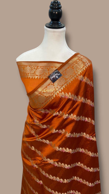 Orange Banarasi Mina Laheriya saree with golden zari border and jacquard detailing