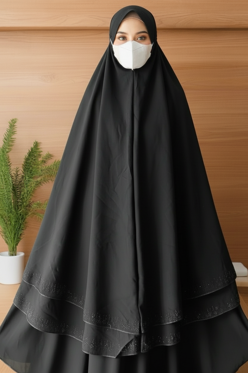 Woman wearing a black hijab and dress against a wooden background