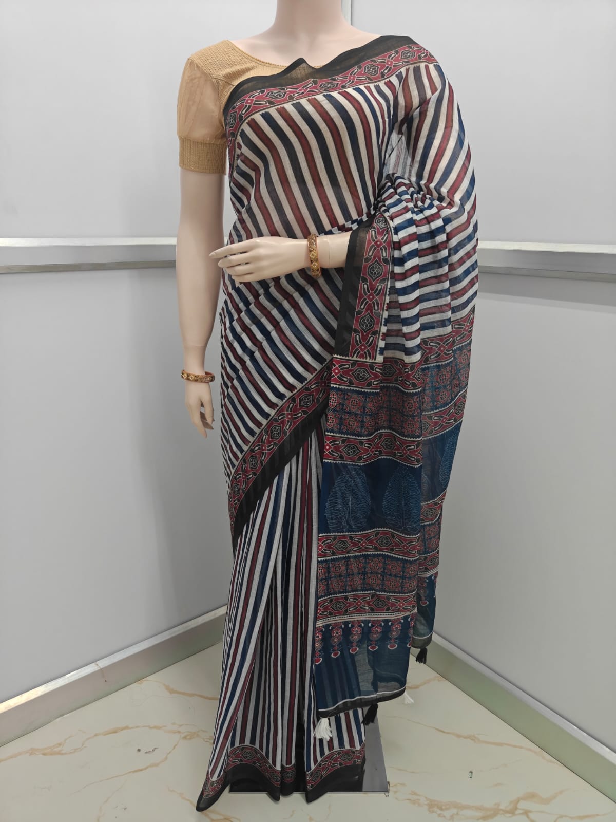 Lightweight Linen Cotton Saree for office and daily wear – soft breathable fabric-Saree with striped pattern on a mannequin against a plain background