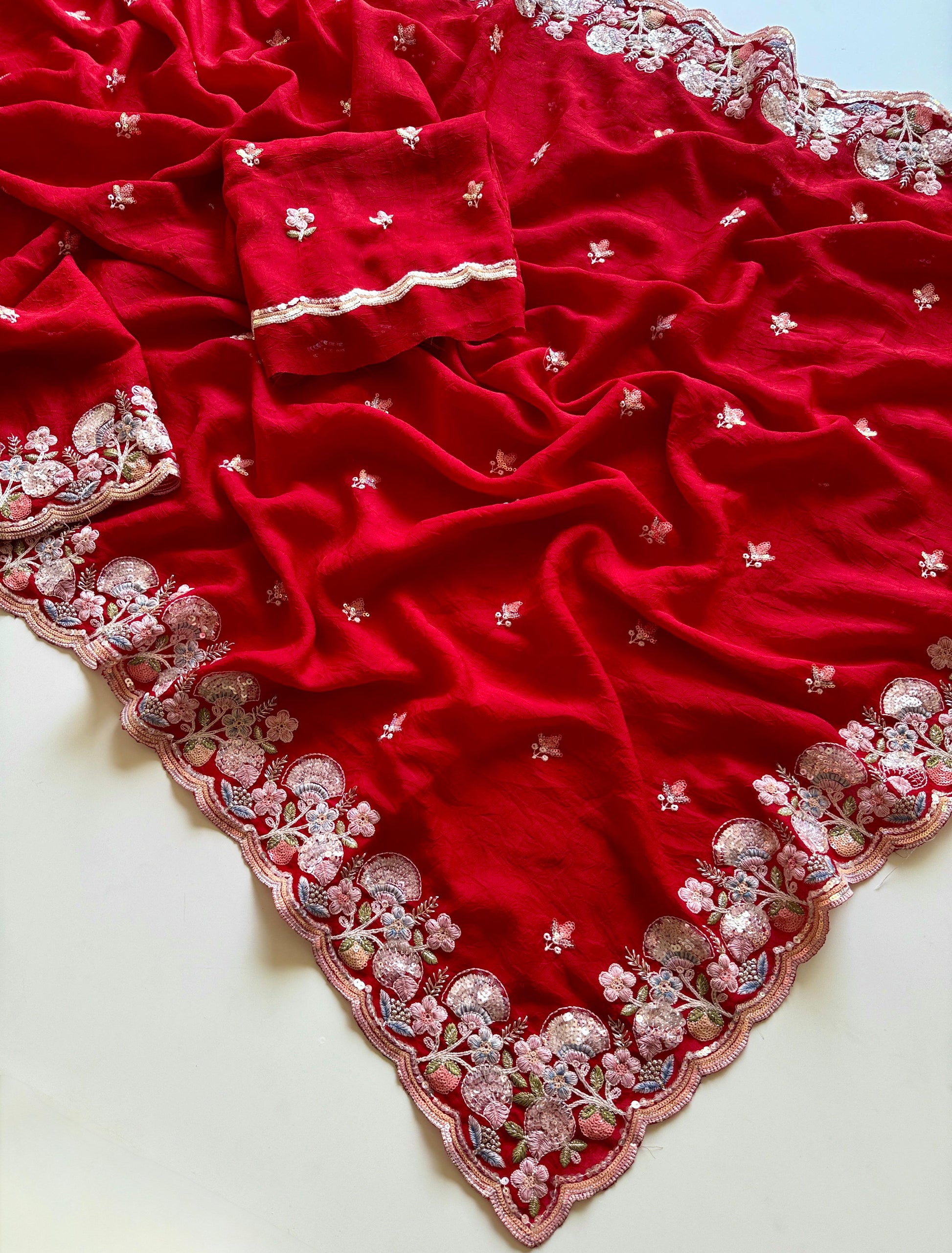 Red fabric with intricate silver embroidery on a white background-Soft crush silk saree with multicolor sequin embroidery