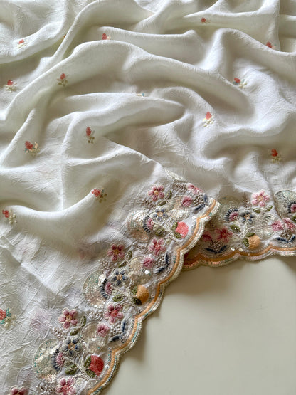 Close-up of a white embroidered fabric with floral patterns on a light background-Multicolor 4m sequin embroidery saree with soft lightweight fabric