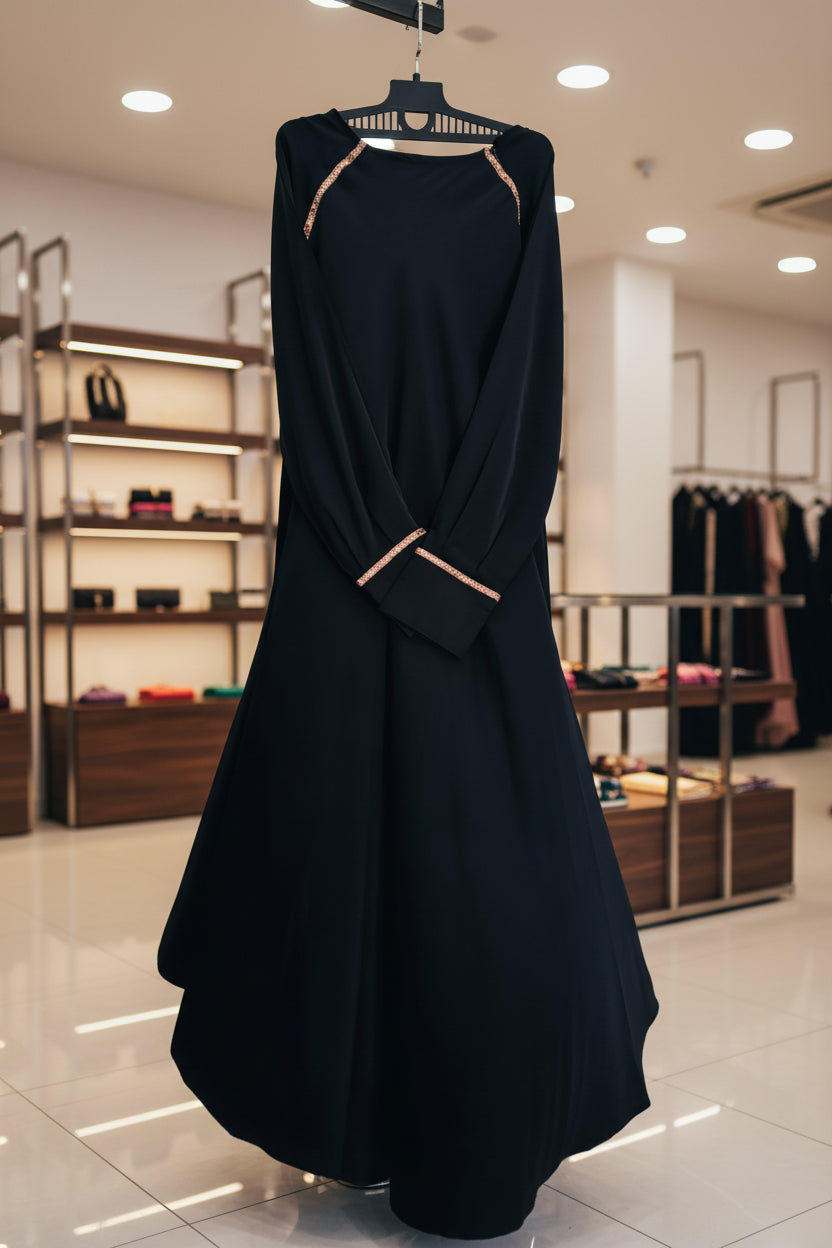 Black umbrella abaya with gold line design on shoulders and sleeve cuffs