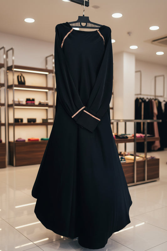 Black umbrella abaya with gold line design on shoulders and sleeve cuffs